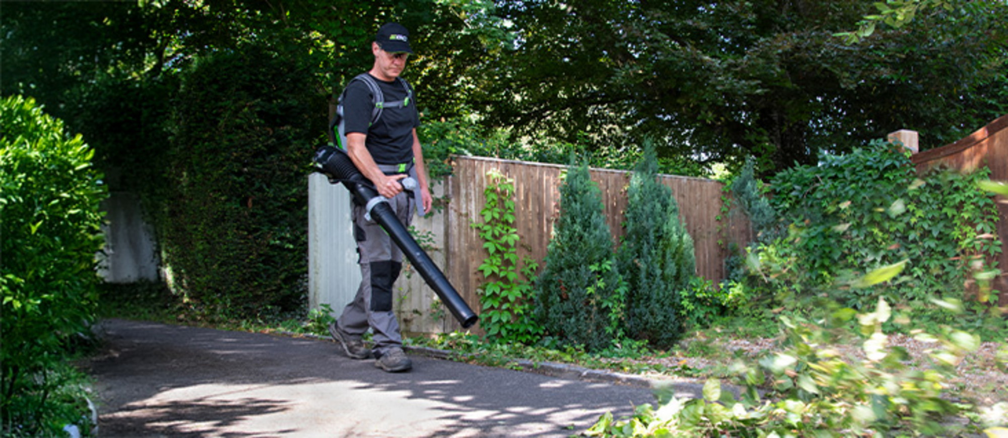 Ein Mann entfernt Laub mit einem rückentragbaren EGO Power+ Laubbläser.