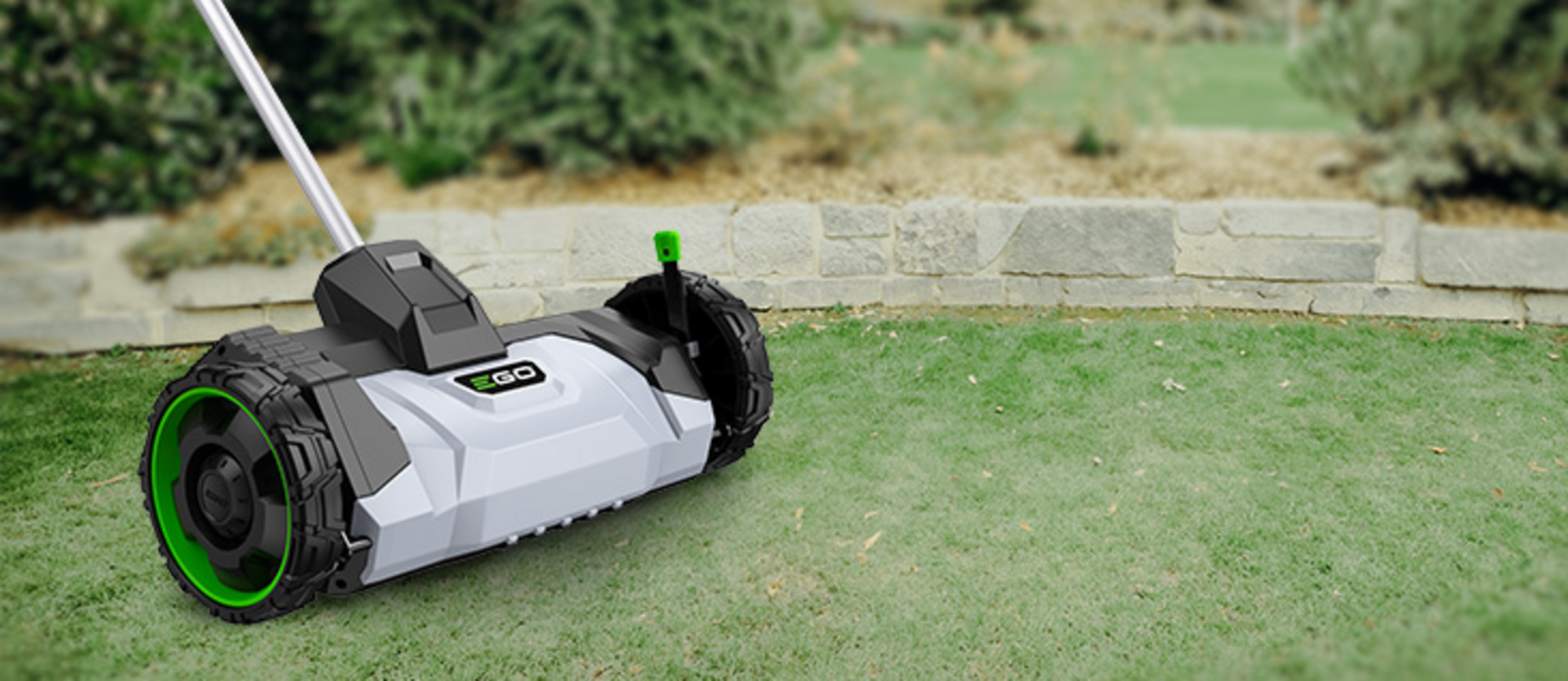 Der Vertikutierer-Aufsatz DA1400 von EGO Power+ auf einer Rasenfläche.