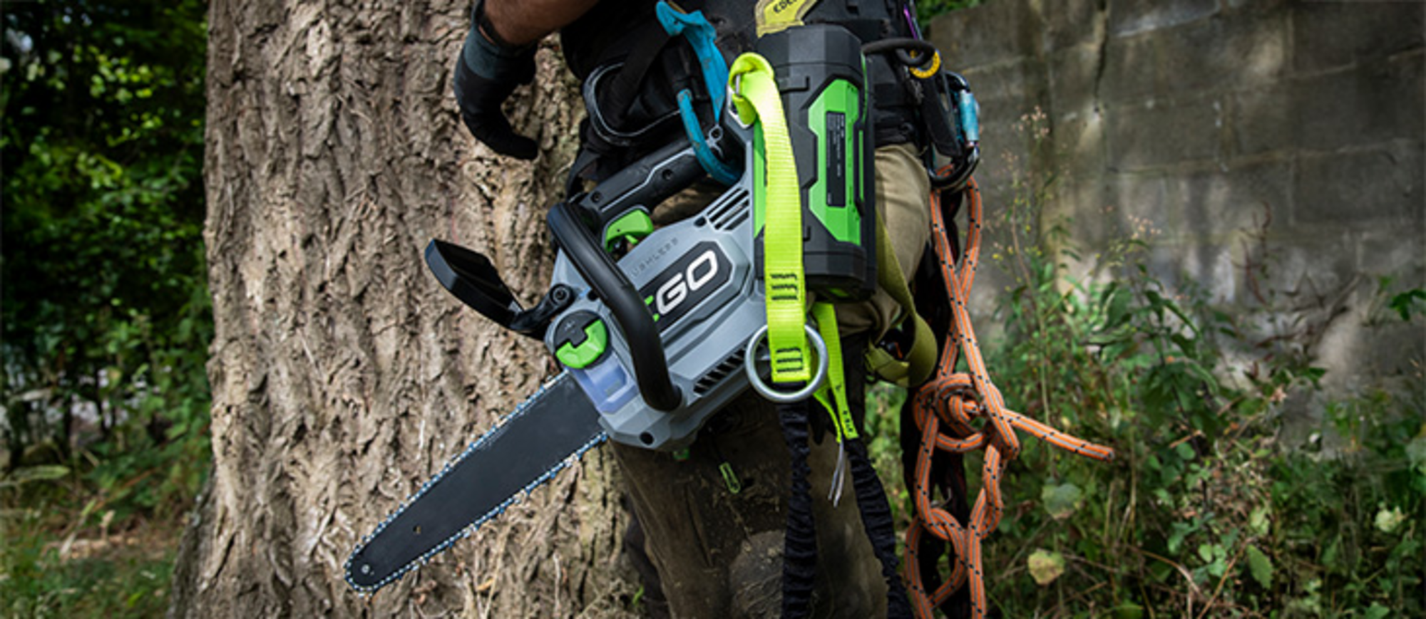 EGO Power+ Akku-Kettensäge CS1200E hängt an einem Werkzeuggürtel.